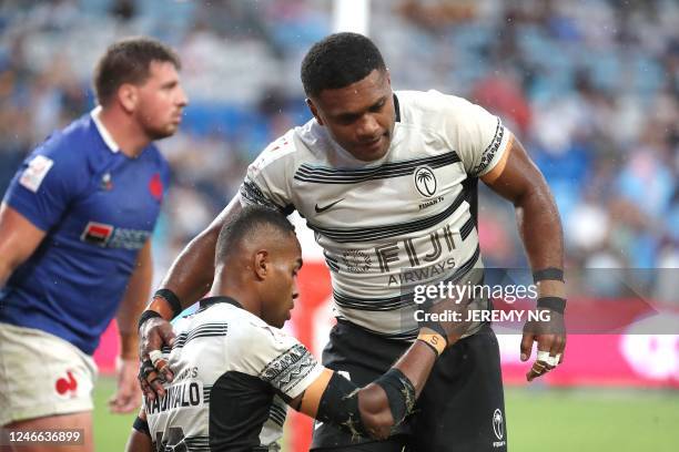 Fiji's Viwa Naduvalo celebrates scoring a try with a teammate during the World Rugby Sevens series match between Fiji and France at the Allianz...