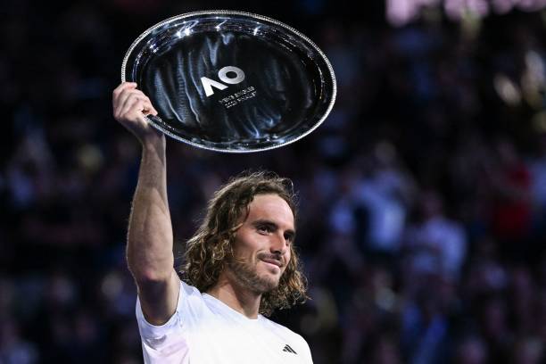 Greece's Stefanos Tsitsipas holds up his trophy after defeat against Serbia's Novak Djokovic during the men's singles final on day fourteen of the...