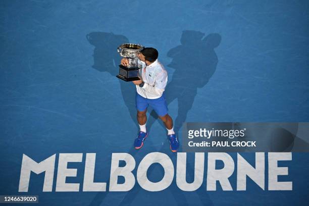 Serbia's Novak Djokovic celebrates with the Norman Brookes Challenge Cup trophy following his victory against Greece's Stefanos Tsitsipas in the...