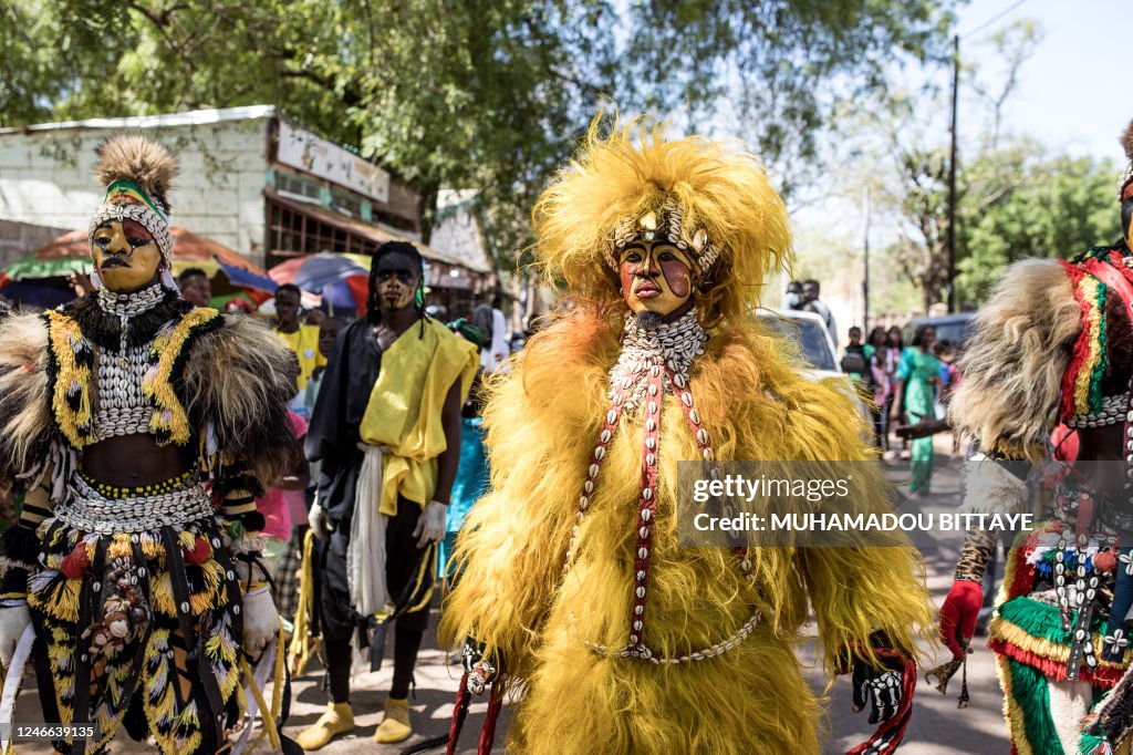 Men Wearing The Simba Mask A Famous Seneglese Culture Attire Of men-wearing-the-simba-mask-a-famous-seneglese-culture-attire-of