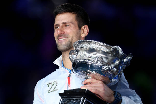 Serbia's Novak Djokovic celebrates with the Norman Brookes Challenge Cup trophy following his victory against Greece's Stefanos Tsitsipas in the...