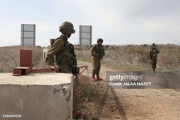 Israeli soldiers patrol next to section of the border fence between the Israeli-annexed Golan Heights and Syria on January 29 after Israeli soldiers...