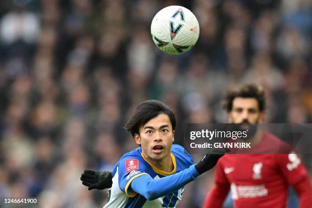 Brighton's Japanese midfielder Kaoru Mitoma keeps his eyes on the ball during the English FA Cup fourth round football match between Brighton & Hove...