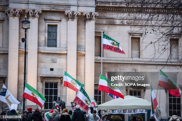 Protestors wave Iranian flags during the "Support Iran's Revolution" Protest. Protestors rallied at Trafalgar Square in London in support of women in...