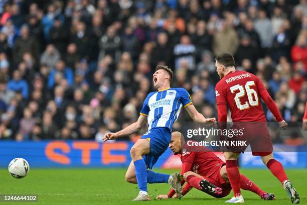 Liverpool's Brazilian midfielder Fabinho fouls Brighton's Irish striker Evan Ferguson during the English FA Cup fourth round football match between...