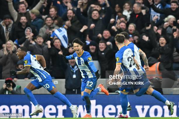 Brighton's Japanese midfielder Kaoru Mitoma celebrates with teammates after scoring their second goal during the English FA Cup fourth round football...