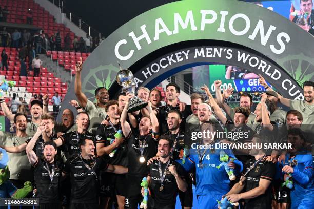 Germany's players pose with the trophy after winning the FIH men's Hockey World Cup 2023 final match against Belgium at the Kalinga Stadium in...