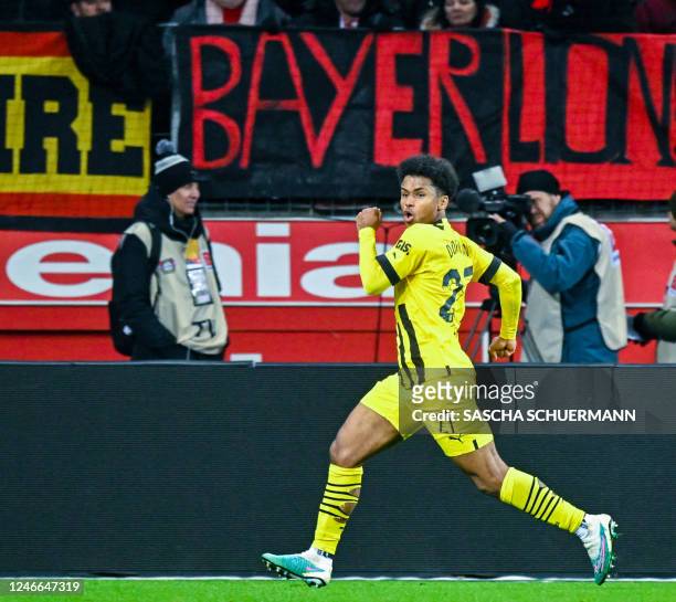 Dortmund's German forward Karim Adeyemi celebrates scoring the 0-1 goal during the German first division Bundesliga football match between Bayer 04...