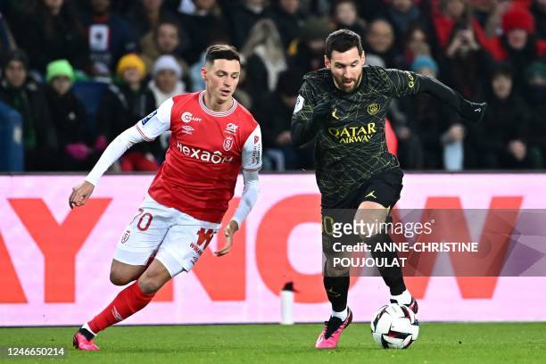 Paris Saint-Germain's Argentine forward Lionel Messi fights for the ball with Paris Saint-Germain's French goalkeeper Lucas Lavallee during the...