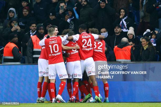 Reims' players celebrate after scoring their first goal during the French L1 football match between Paris Saint-Germain and Stade de Reims at the...