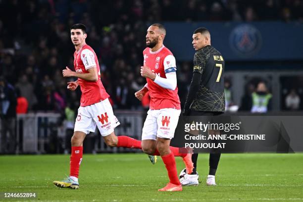 Paris Saint-Germain's French forward Kylian Mbappe reacts after Reims scored an equalising goal during the French L1 football match between Paris...