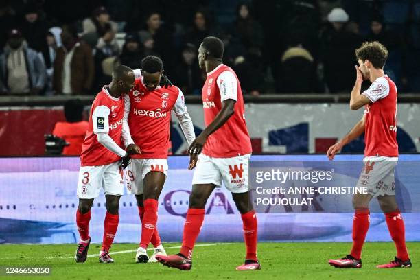 Reims' English forward Folarin Balogun celebrates with teammates after scoring his team's first goal during the French L1 football match between...