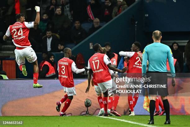 Reims' English forward Folarin Balogun celebrates with teammates after scoring his team's first goal during the French L1 football match between...