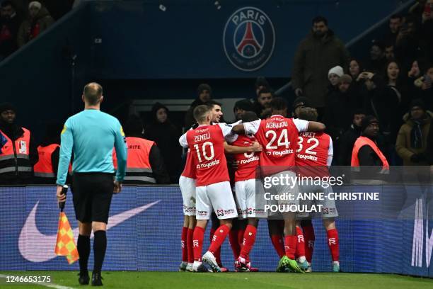 Reims' players celebrate their first goal during the French L1 football match between Paris Saint-Germain and Stade de Reims at the Parc des Princes...