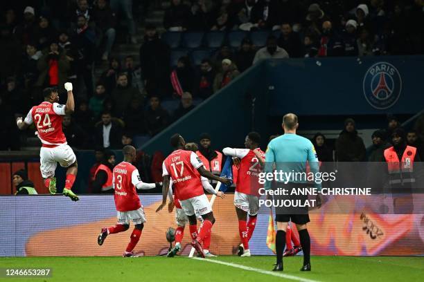 Reims' English forward Folarin Balogun celebrates with teammates after scoring his team's first goal during the French L1 football match between...