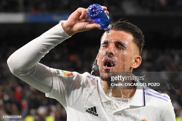 Real Madrid's Spanish midfielder Dani Ceballos pours water on his face during the Spanish league football match between Real Madrid CF and Real...