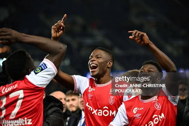 Reims' players celebrate after winning the French L1 football match between Paris Saint-Germain and Stade de Reims at the Parc des Princes stadium in...