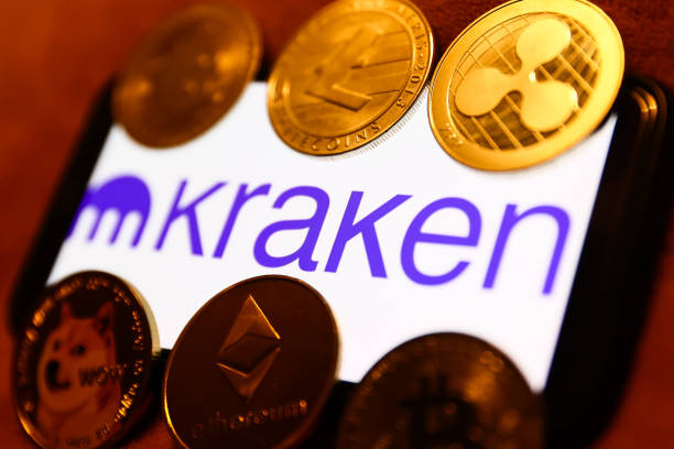 Kraken logo displayed on a phone screen and representation of cryptocurrencies are seen in this illustration photo taken in Krakow, Poland on January...