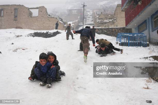 Children enjoy snow during snowfall in Kabul, Afghanistan on January 29, 2023.