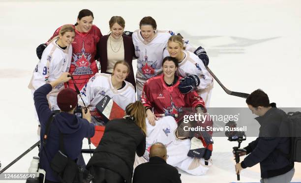 Members of the Metropolitan Riveters pose for a photo after the game as members of the Premier Hockey Federation All-Stars play in their All-Star...