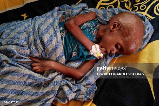 Graphic content / A malnourished child rests on a bed at the nutrition unit of the K'elafo Health Center, in the town of K'elafo, Ethiopia, on...