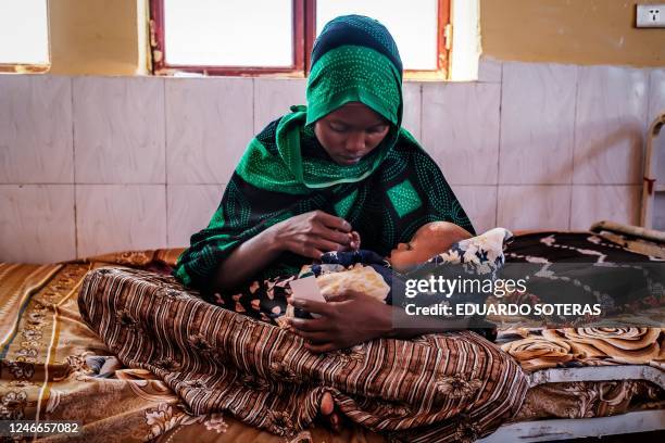 Woman holds a malnourished child at the nutrition unit of the Gode General Hospital, in the city of Gode, Ethiopia, on January 13, 2023. - The last...