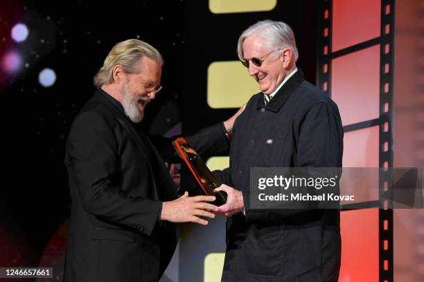 Bone Burnett presents Jeff Bridges the Best Actor TV award for "The Old Man" onstage during the AARP Annual Movies for Grownups Awards - Show at...