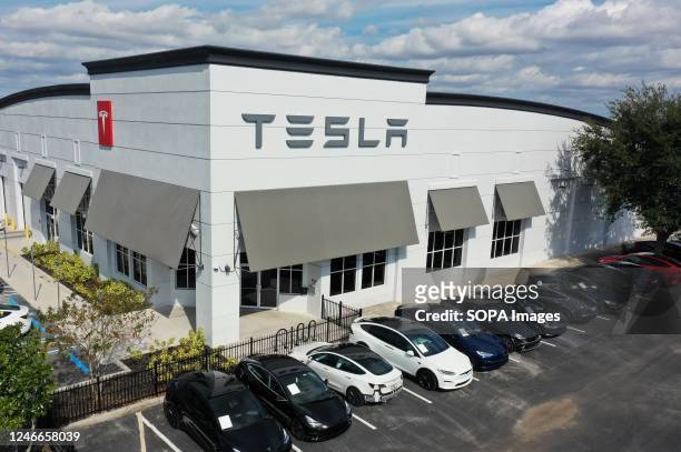 Image taken with a drone) A Tesla collision center is seen in this aerial view in Orlando. Shares of Tesla stock increased 33% this week, marking...