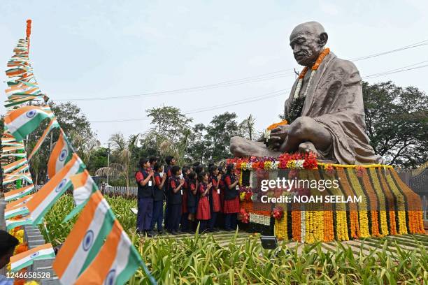 School students pay their respects on the statue of Mahatma Gandhi on his death anniversary in Hyderabad on January 30, 2023. - The death anniversary...