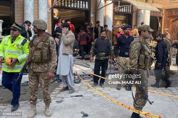 Security personnel cordon off the site of a mosque blast inside the police headquarters in Peshawar on January 30, 2023. - At least 25 people were...