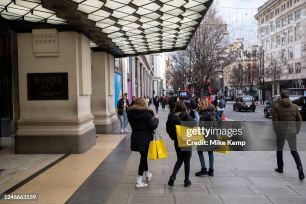 Shoppers with yellow Selfridges shopping bags out on Oxford Street on 9th January 2023 in London, United Kingdom. Oxford Street is a major retail...