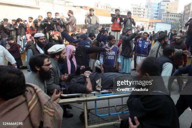 An injured is being shifted into a hospital following blast inside a mosque during midday prayers in the northwest city of Peshawar, Pakistan, on...