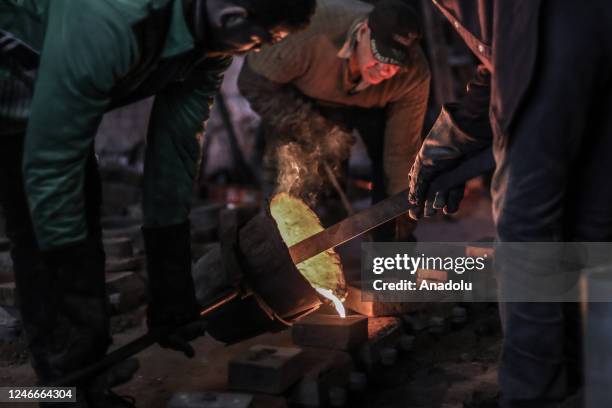 Casting workers melt scrap metal at a foundry workshop in Alexandria, Egypt on January 19, 2023. Workers melt and reshape used metals in moulds at a...