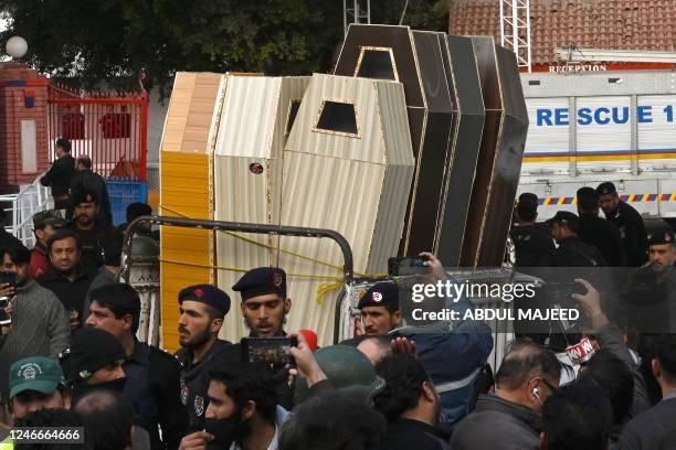 Vehicle transports caskets for bodies of the victims who died in a mosque blast inside the police headquarters in Peshawar on January 30, 2023. - A...