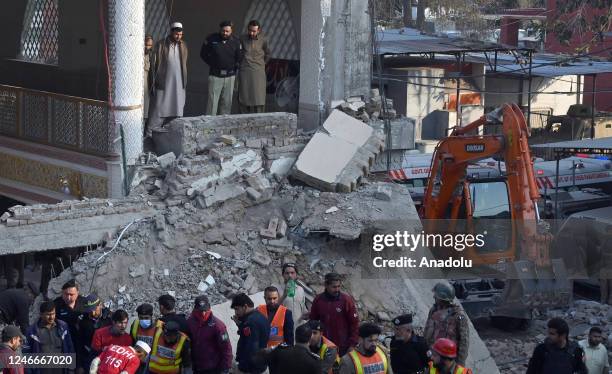 Heavy machinery is being used to clear the collapsed debris to find the survivors trapped under the rubble following a blast inside a mosque during...