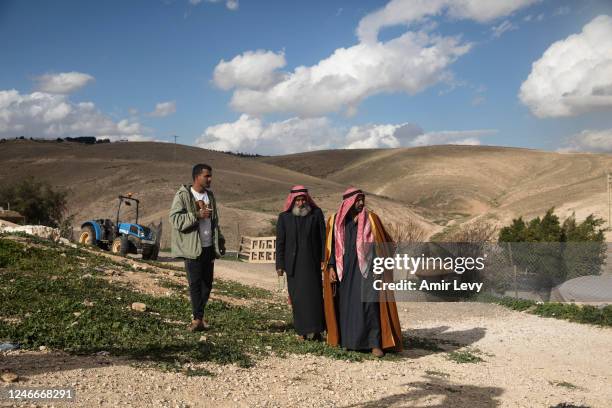 Bedouin men stand in the village of Khan Al-Ahmar on January 30, 2023 in Kan al-Ahmar, West Bank. In 2018, Israel's High Court said the village's...