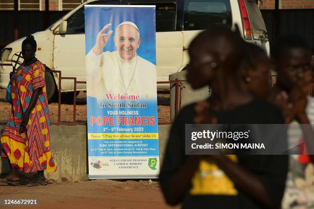 Members of the Diocesan catholic choir of the archdiocese of Juba attend a practice session, with a banner showing the portrait of Pope Francis,...