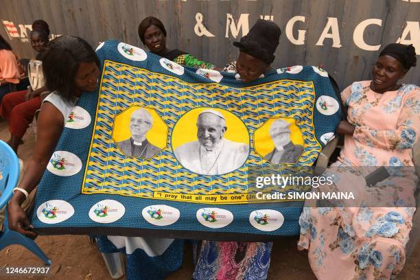 South-Sudanese women hold a printed fabric showing the portrait of Pope Francis as preparations continue ahead of his visit in Juba, on January 30,...