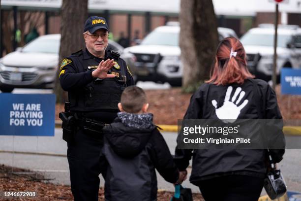 Sgt. Jamie Huling of the Newport News Police Department greets students as they return to Richneck Elementary in Newport News, Virginia, on Monday,...
