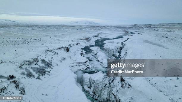 Drone view of snow covered Gullfoss Falls in Haukadalur Valley, Iceland, on January 23, 2023. -Gullfoss is one of Icelands most iconic waterfalls....