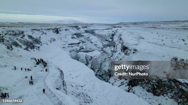 Drone view of snow covered Gullfoss Falls in Haukadalur Valley, Iceland, on January 23, 2023. -Gullfoss is one of Icelands most iconic waterfalls....