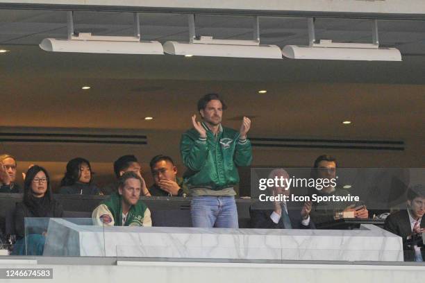 Actor Bradley Cooper watches from the owners box during the Championship game between the San Fransisco 49ers and the Philadelphia Eagles on January...