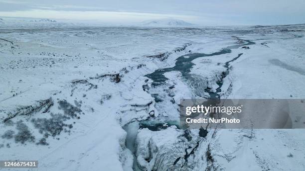 Drone view of snow covered Gullfoss Falls in Haukadalur Valley, Iceland, on January 23, 2023. -Gullfoss is one of Icelands most iconic waterfalls....