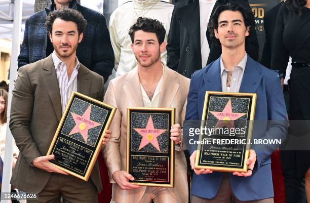 The Jonas Brothers, from L to R, Kevin Jonas, Nick Jonas and Joe Jonas, pose at their Hollywood Walk of Fame Star ceremony on January 30, 2023 in...