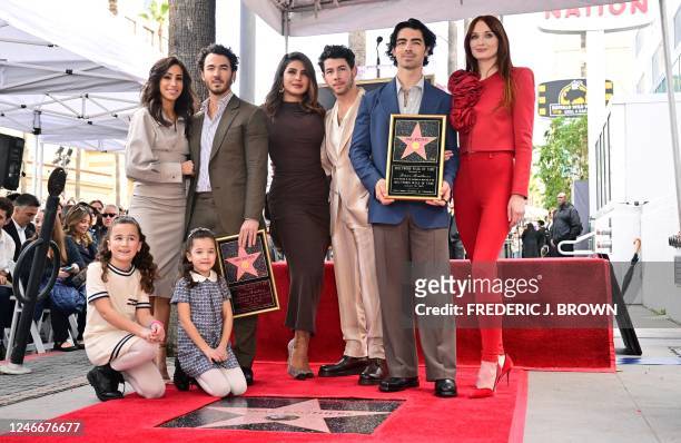 The Jonas Brothers, Kevin Jonas , Nick Jonas and Joe Jonas , pose with their wives and children beside their Hollywood Walk of Fame Star after it was...