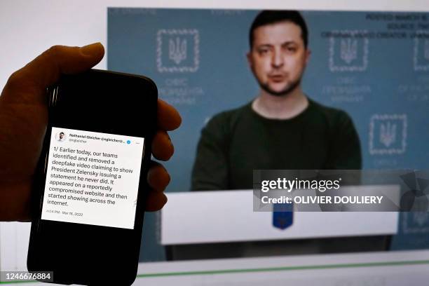 This illustration photo taken on January 30, 2023 shows a phone screen displaying a statement from the head of security policy at META with a fake...