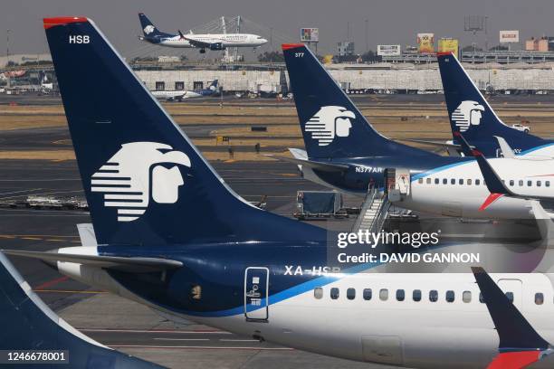 Jet of Mexican flag carrier airline Aeromexico lands as otheres are parked at Mexico City's Benito Juarez International Airport on January 30, 2023.