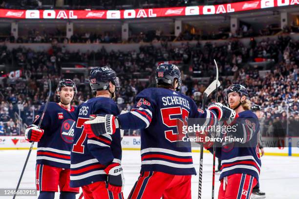 Kyle Capobianco, Nikolaj Ehlers, Mark Scheifele and Kyle Connor of the Winnipeg Jets celebrate a third period goal against the St. Louis Blues at the...