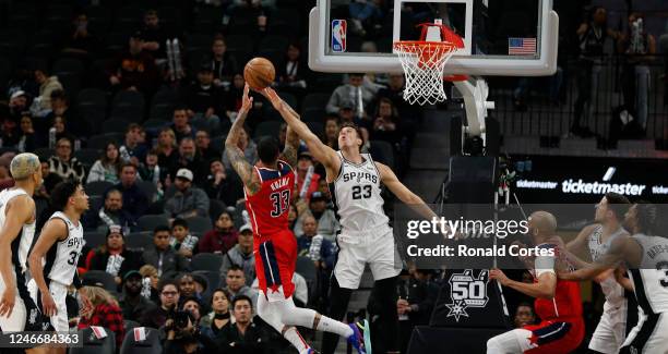 Zach Collins of the San Antonio Spurs blocks the shot of Kyle Kuzma of the Washington Wizards but was called for a foul in the second half at AT&T...