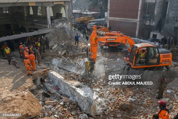 Security personnel and rescue workers search for victims amid the debris of a damaged mosque a day after a blast inside the police headquarters in...